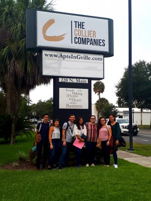 Students pose in front of the TCC HO Sign