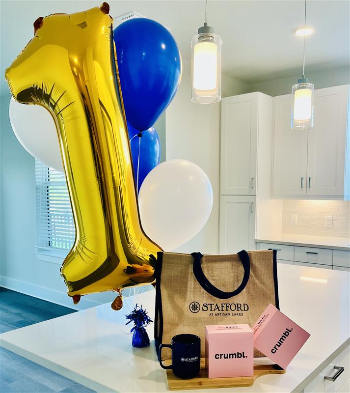 Move In Welcome Gifts, including balloons, crumbl cookies and Stafford branded items.